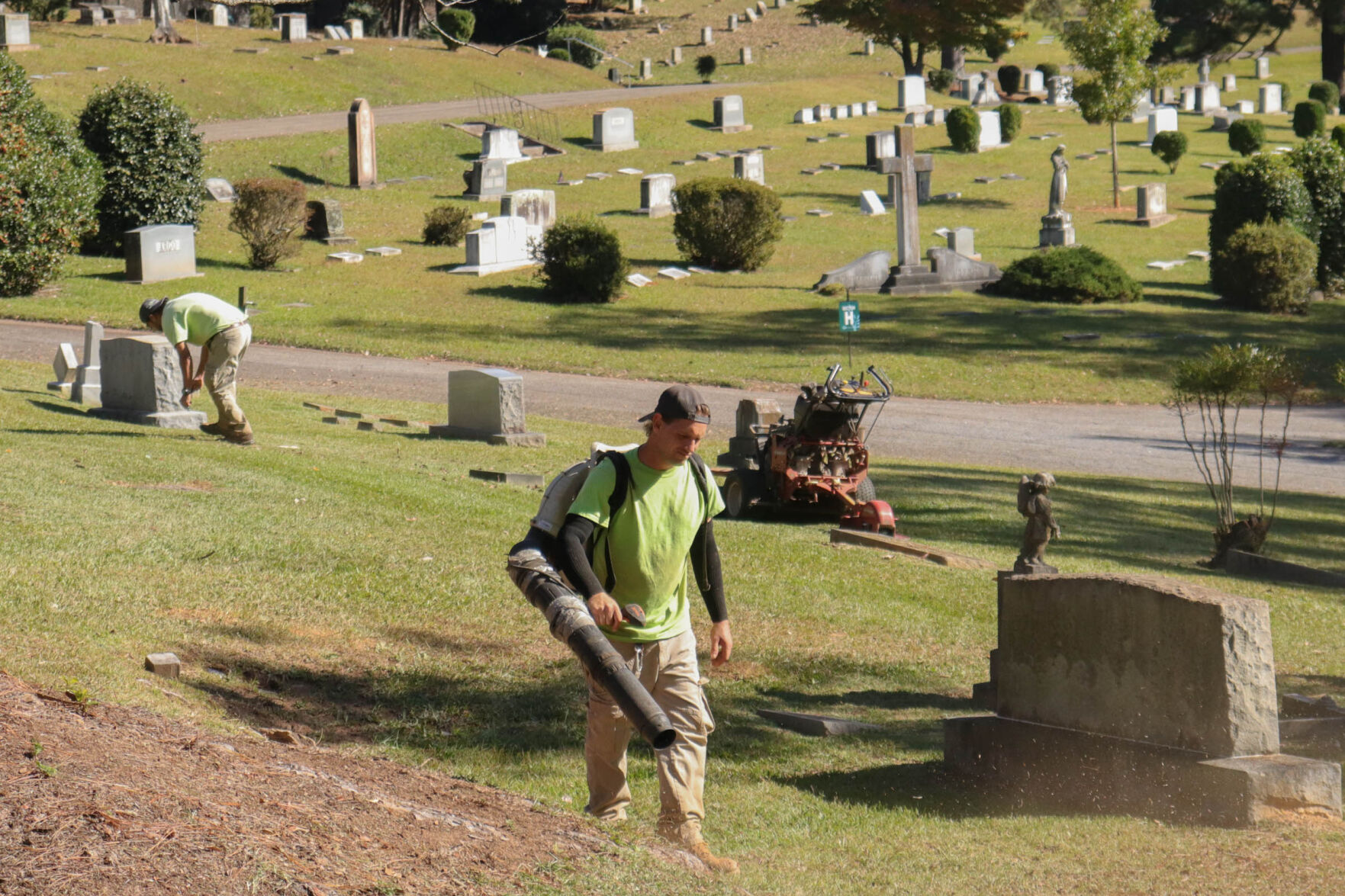 caretakers at the oconee hill cemetery work on the grounds